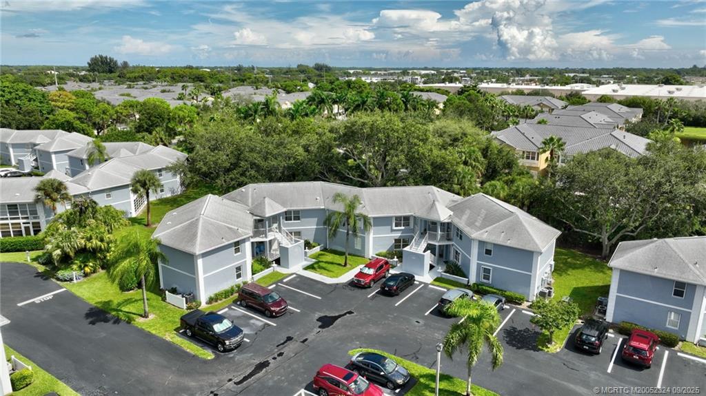 3260 Southeast Aster Lane, Unit I241 Stuart, FL 34994 - Photo 38 of 48 an aerial view of a houses with garden