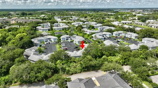 an aerial view of a house with garden space and street view