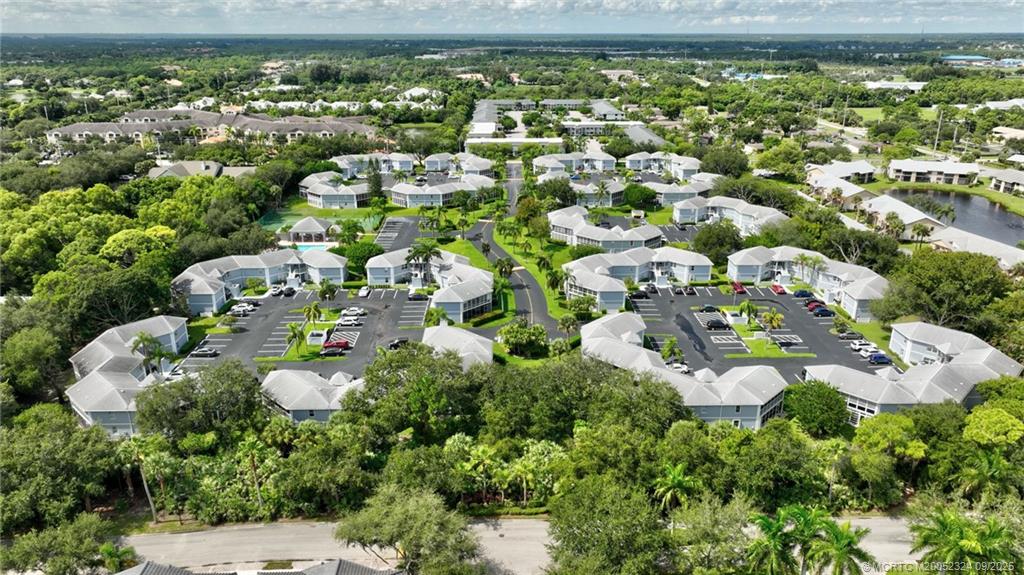3260 Southeast Aster Lane, Unit I241 Stuart, FL 34994 - Photo 45 of 48 an aerial view of residential houses with outdoor space and trees