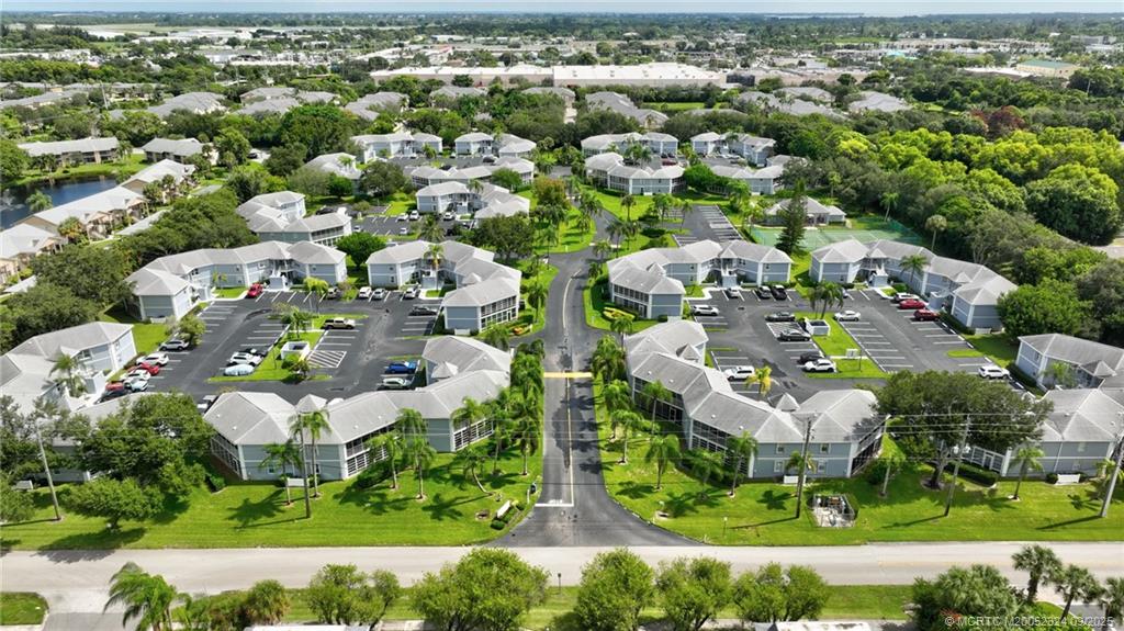 3260 Southeast Aster Lane, Unit I241 Stuart, FL 34994 - Photo 47 of 48 an aerial view of residential houses with outdoor space