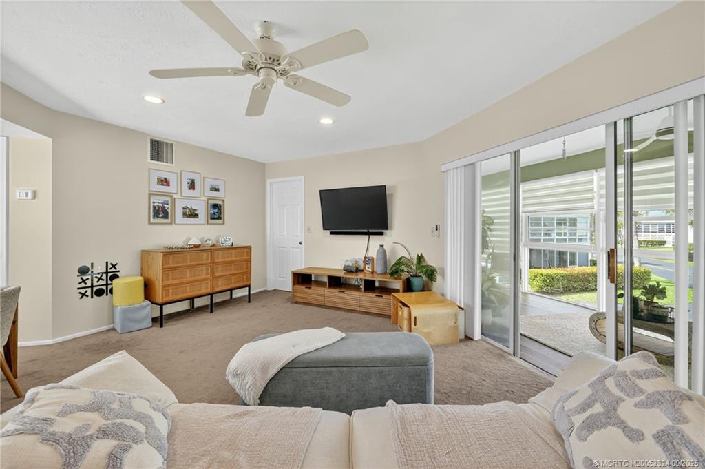 3260 Southeast Aster Lane, Unit I241 Stuart, FL 34994 - Photo 6 of 48 a living room with furniture and a flat screen tv