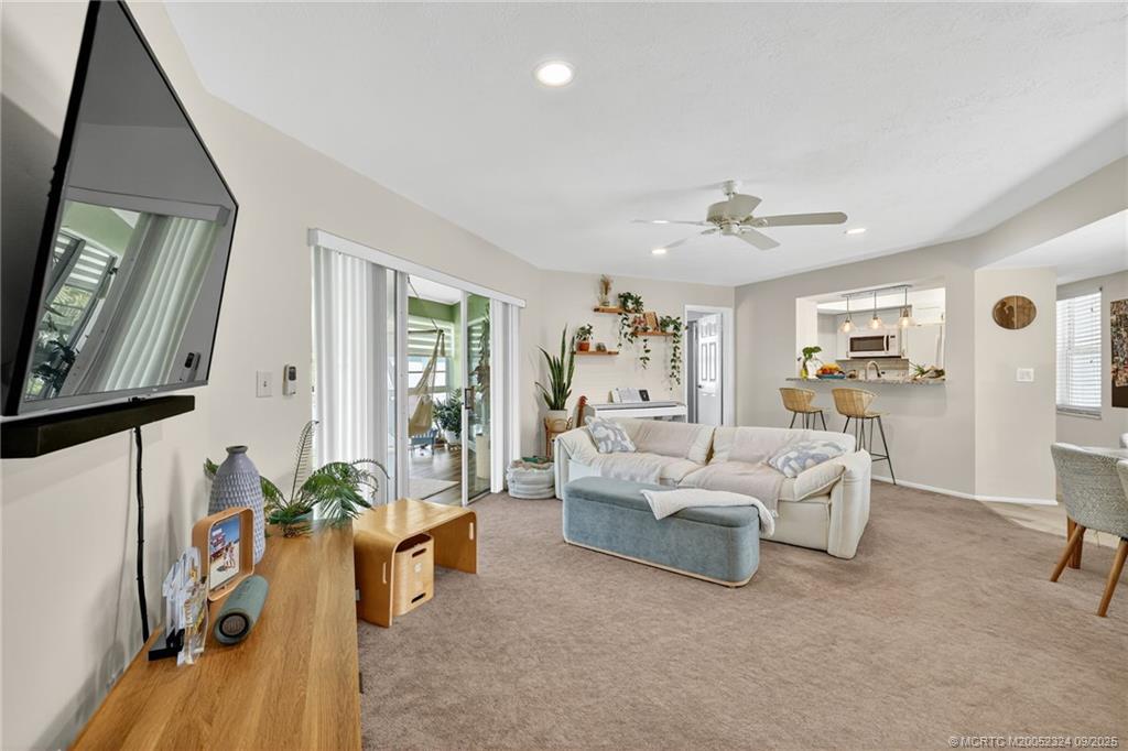 3260 Southeast Aster Lane, Unit I241 Stuart, FL 34994 - Photo 7 of 48 a living room with furniture and a flat screen tv