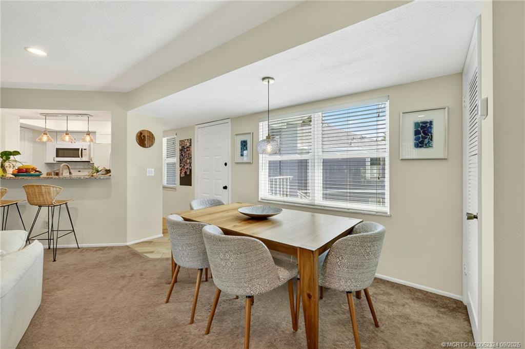 3260 Southeast Aster Lane, Unit I241 Stuart, FL 34994 - Photo 9 of 48 a dining room with furniture and window
