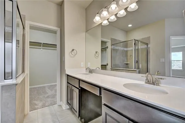 a bathroom with a sink double vanity and a shower