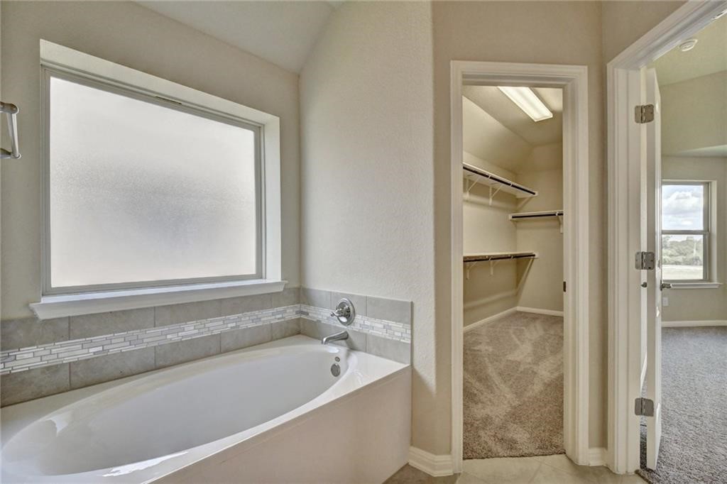 2208 Cabrillo Path Leander, TX 78641 - Photo 14 of 23 a bathroom with a bathtub and shower