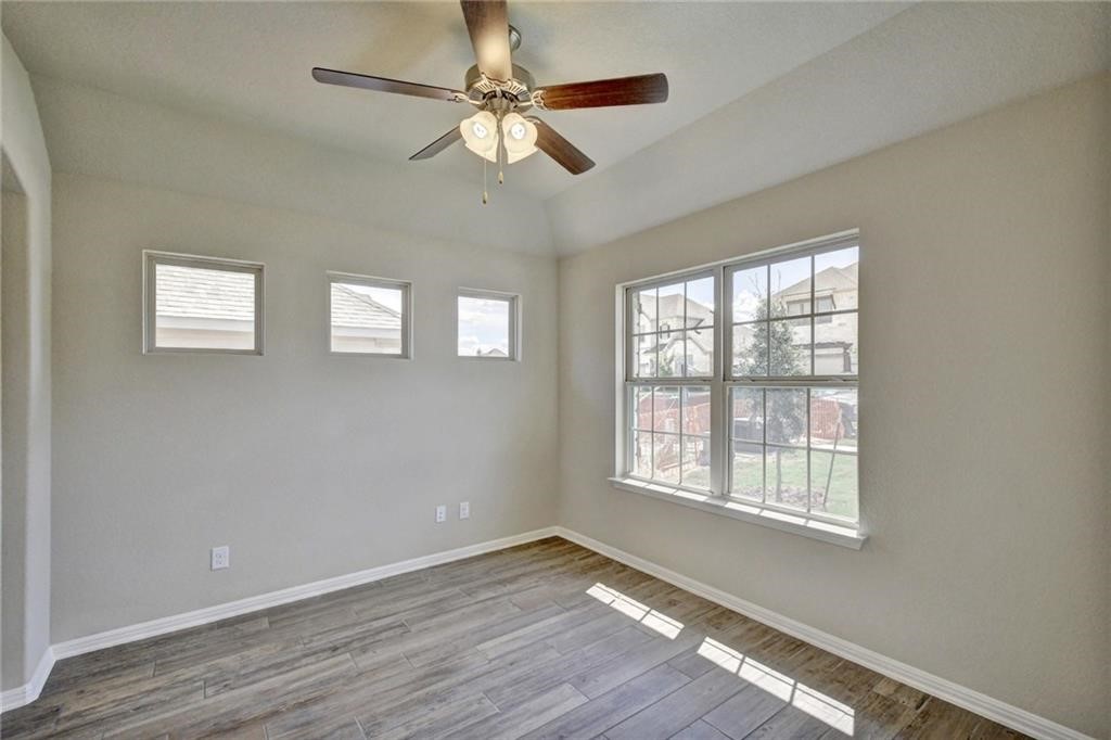 2208 Cabrillo Path Leander, TX 78641 - Photo 16 of 23 a view of an empty room with wooden floor and a window