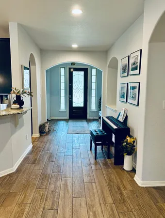 a living room with furniture and wooden floor