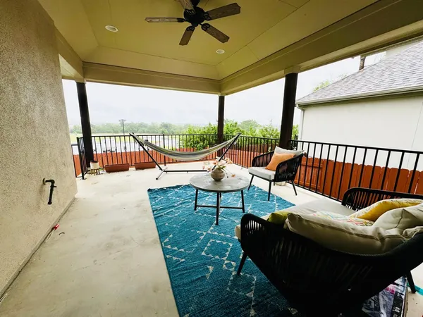 a living room with furniture and a floor to ceiling window