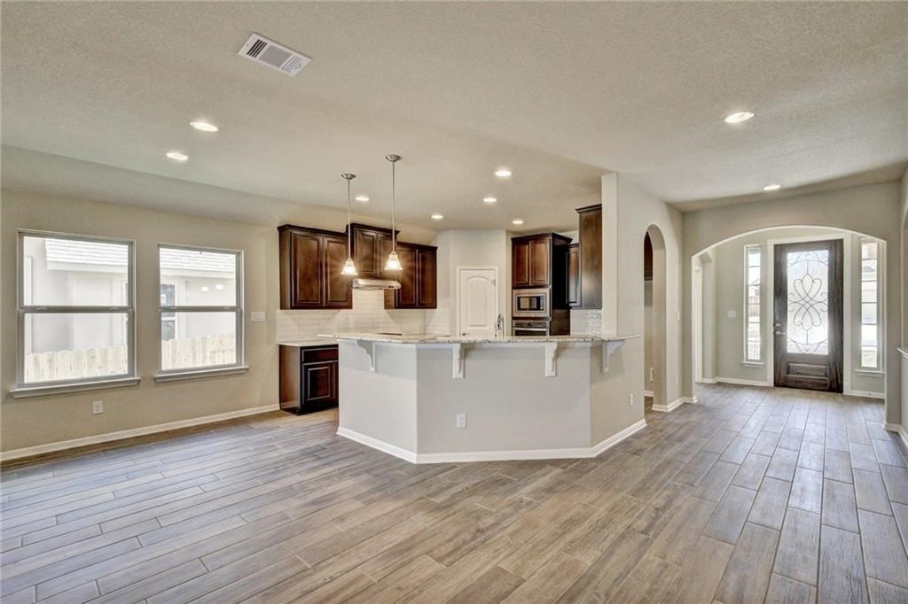 2208 Cabrillo Path Leander, TX 78641 - Photo 6 of 23 an open dining hall with wooden floor and a large window
