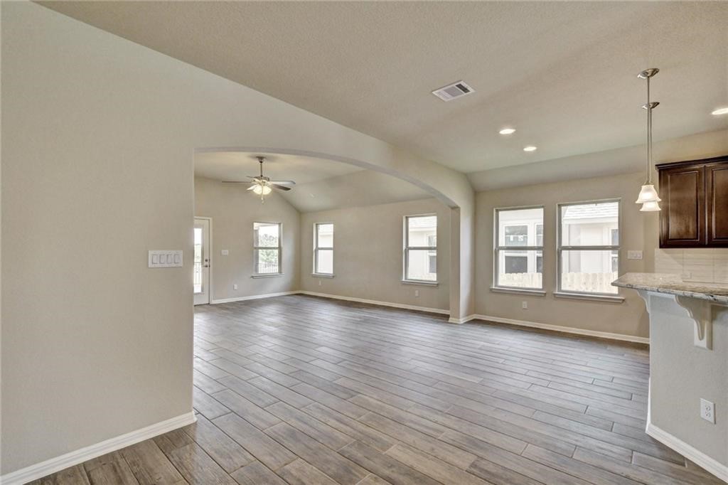 2208 Cabrillo Path Leander, TX 78641 - Photo 10 of 23 a view of an empty room with wooden floor and a window