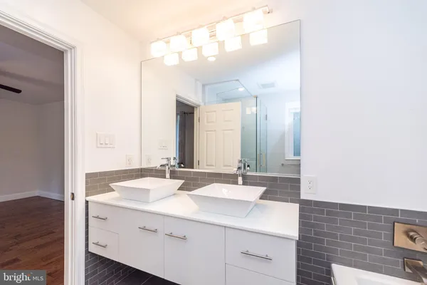 a bathroom with a double vanity sink mirror and double