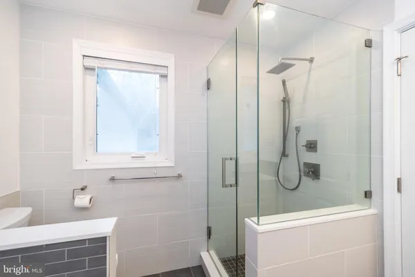a bathroom with a bathtub a sink and a mirror