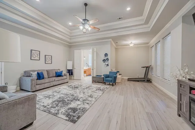 a living room with furniture and a chandelier