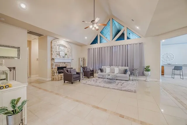a bedroom with furniture and large windows