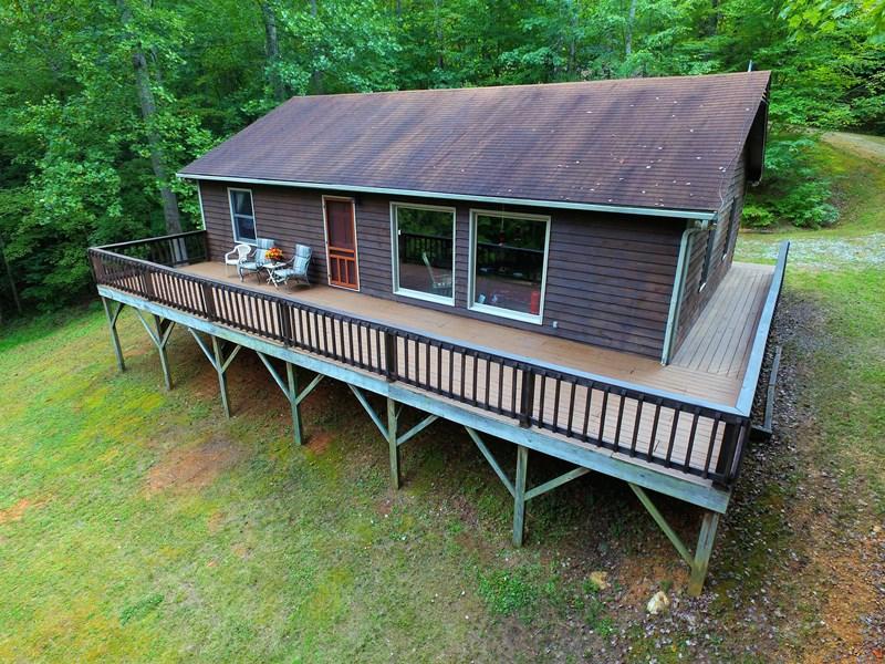 607 Dryhill Road Ferrum, VA 24088 - Photo 21 of 27 a view of a house with a roof deck and a garden