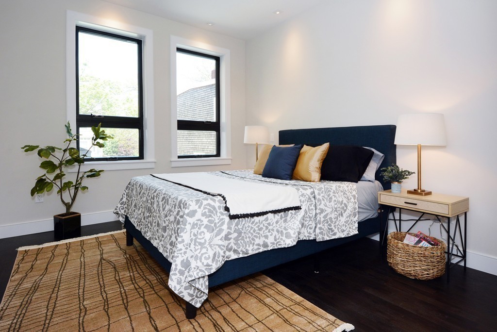 511 East 5th Street, Unit 2 Boston, MA 02127 - Photo 9 of 11 a bedroom with a bed and wooden floor
