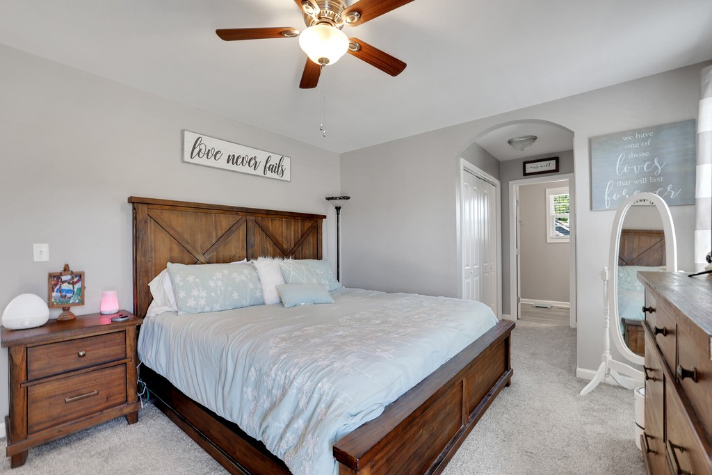 228 Scattersville Road Portland, TN 37148 - Photo 15 of 29 a bedroom with a bed and a chandelier