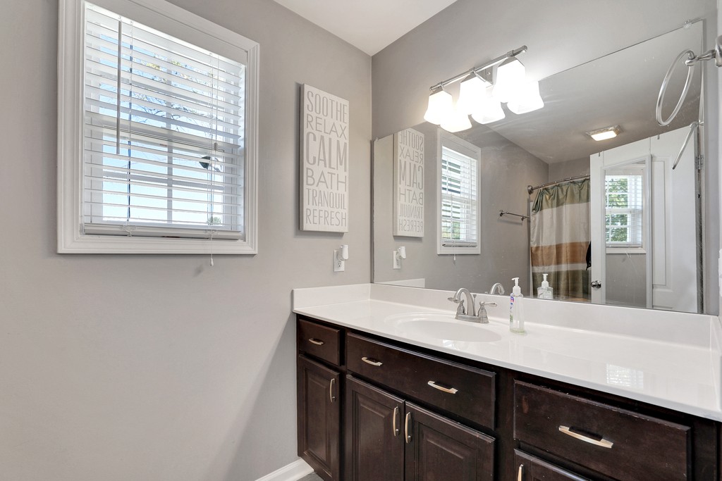 228 Scattersville Road Portland, TN 37148 - Photo 16 of 29 a bathroom with a sink a large mirror and a window