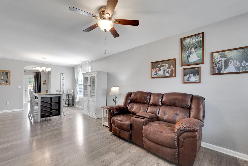 228 Scattersville Road Portland, TN 37148 - Photo 6 of 29 a living room with furniture ceiling fan and a wooden floor