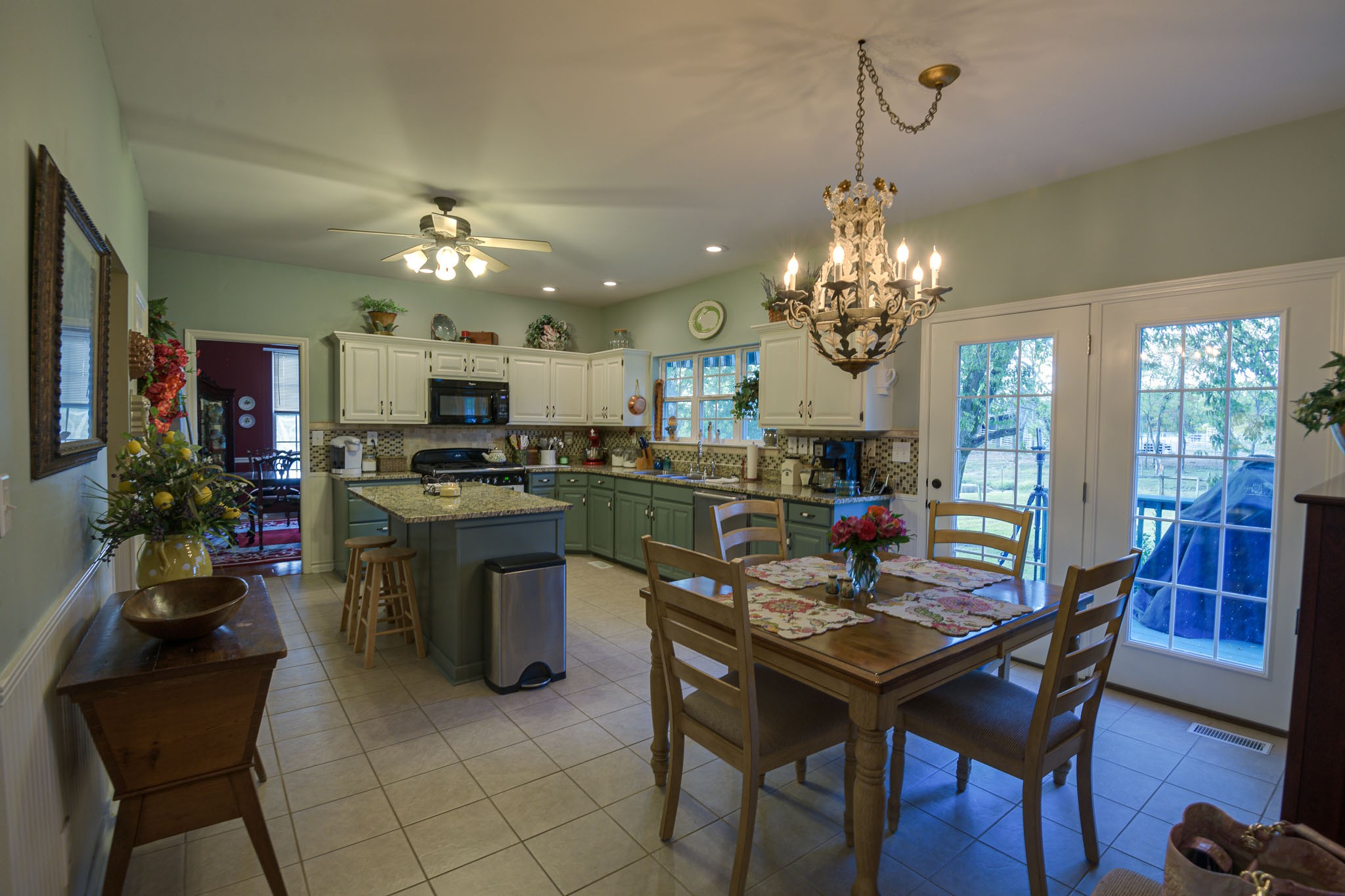 4685 Highway 64 Rutherfordton, NC 28139 - Photo 15 of 50 a kitchen with a dining table cabinets appliances and a chandelier