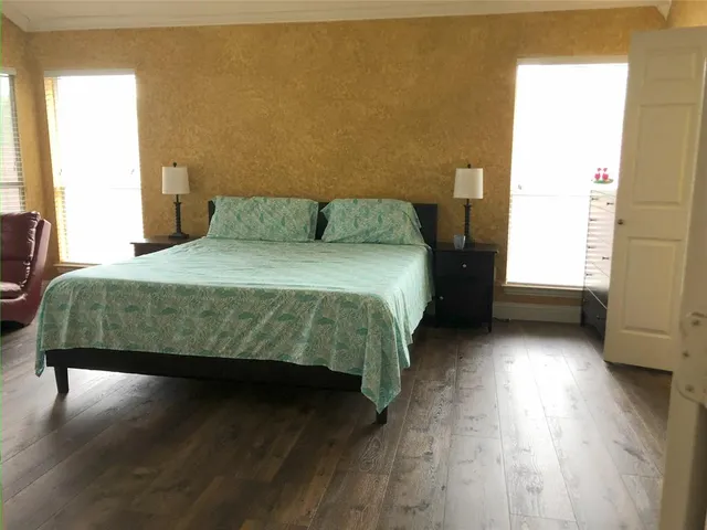 a bedroom with a bed and window