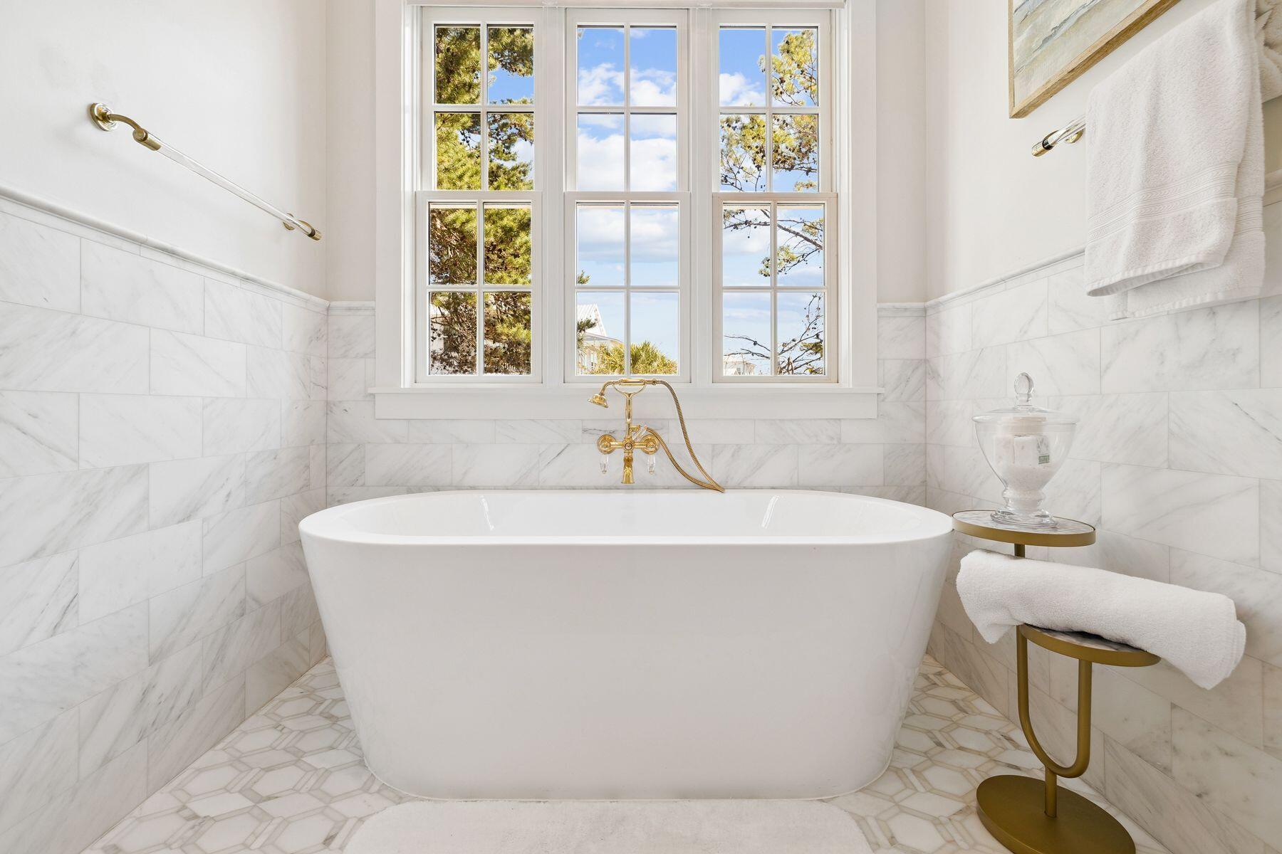 25 Peace Ln Inlet Beach Inlet Beach, FL 32461 - Photo 33 of 85 a white bath tub sitting in a bathroom next to a window