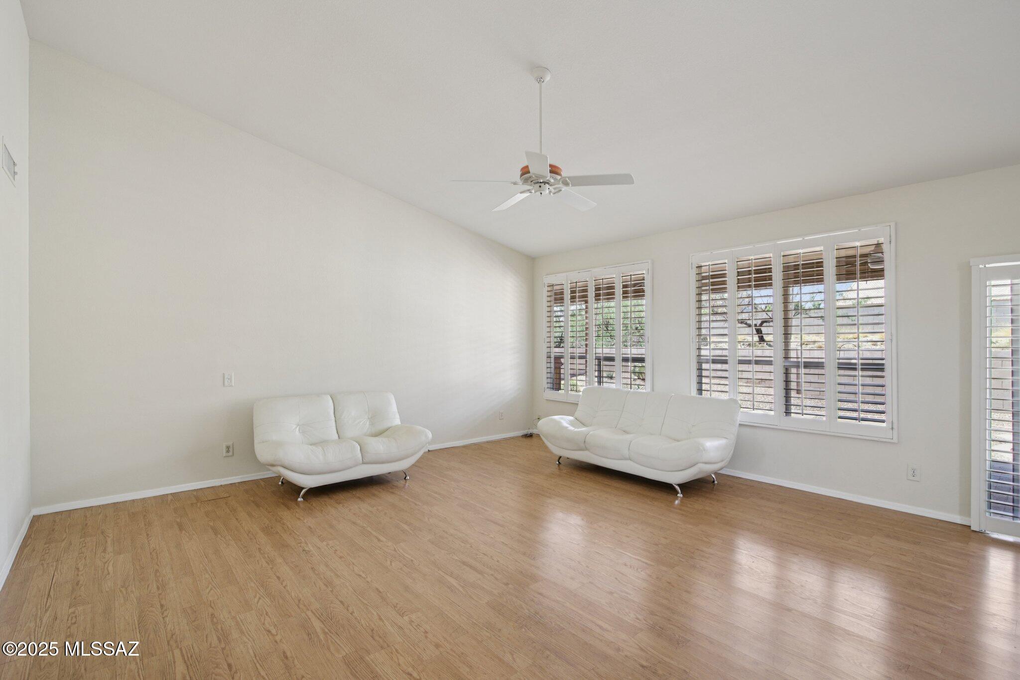 35890 Mesa Ridge Drive Tucson, AZ 85739 - Photo 5 of 31 a living room with furniture and wooden floor