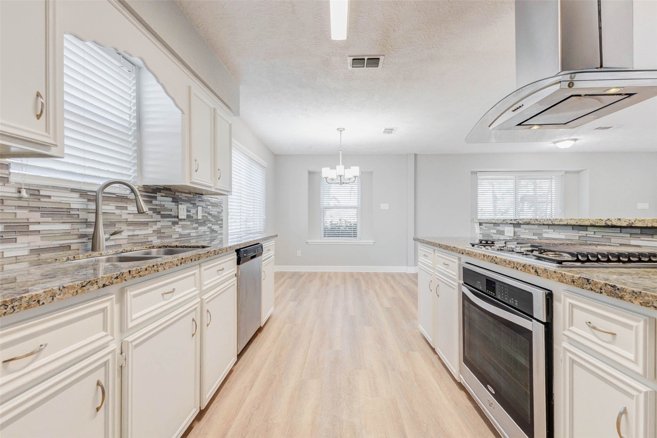 18526 Fenske Road Cypress, TX 77433 - Photo 14 of 32 This functional kitchen layout offers efficient workflow and convenient meal preparation.