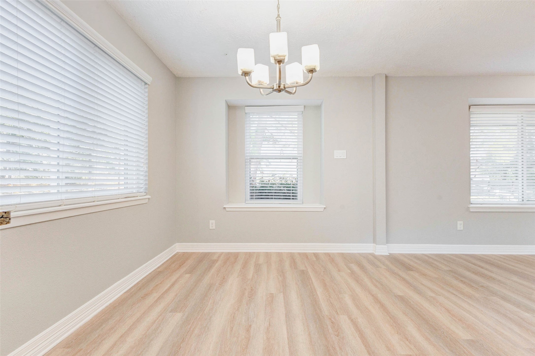 18526 Fenske Road Cypress, TX 77433 - Photo 15 of 32 Just off the kitchen is a spacious breakfast area with vinyl flooring, abundant windows, and an updated chandelier overhead.