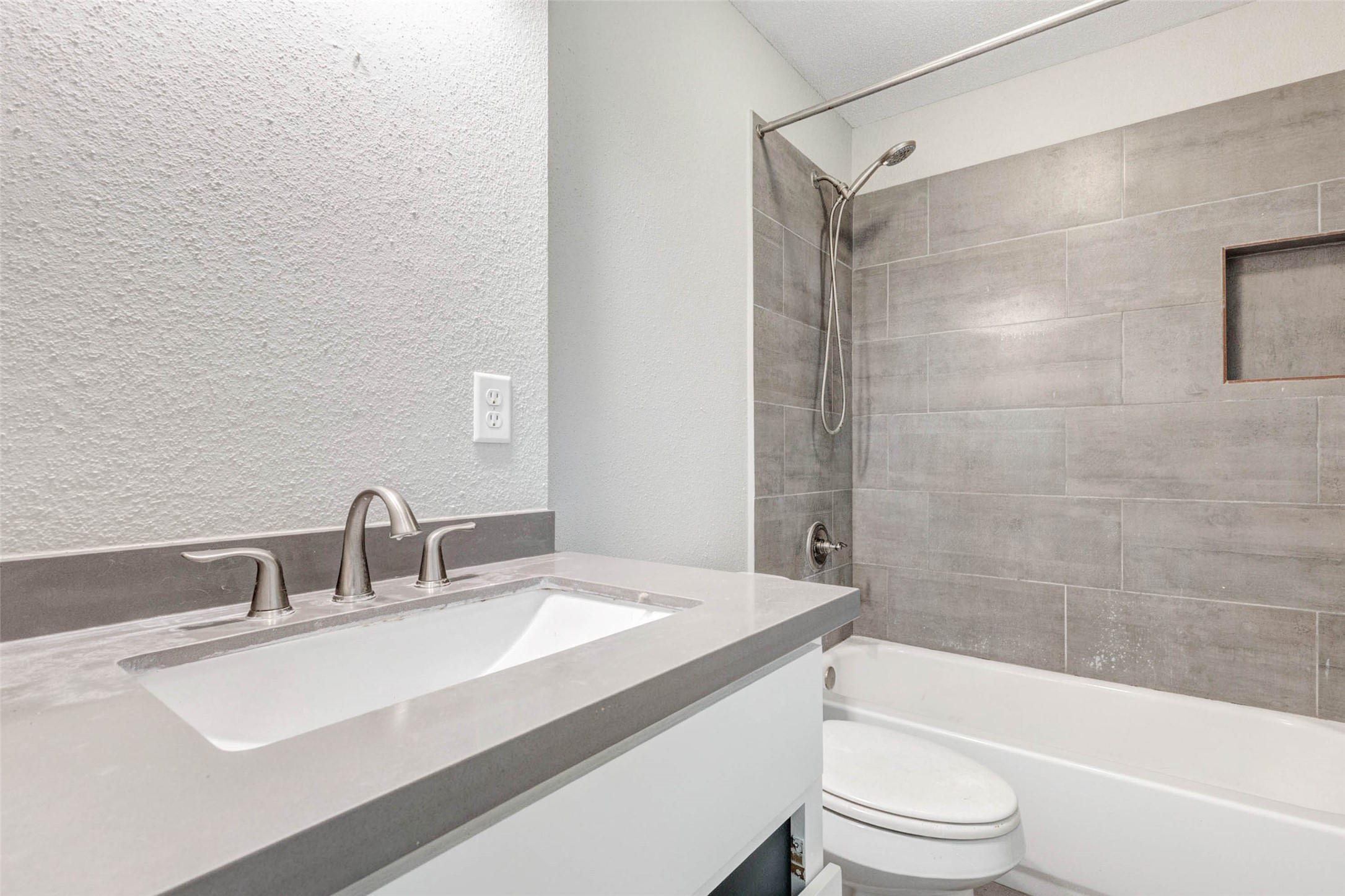 18526 Fenske Road Cypress, TX 77433 - Photo 22 of 32 The primary bathroom features an updated vanity with sleek countertops, brushed nickel fixtures, and a tub and shower combination with a neutral tile surround.