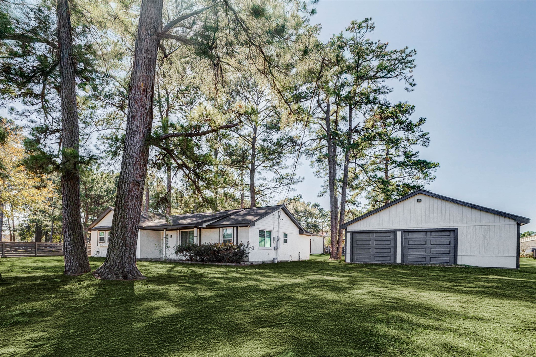 18526 Fenske Road Cypress, TX 77433 - Photo 3 of 32 Surrounded by mature trees and lush landscaping, this updated home is move in ready and includes an oversized detached two car garage.