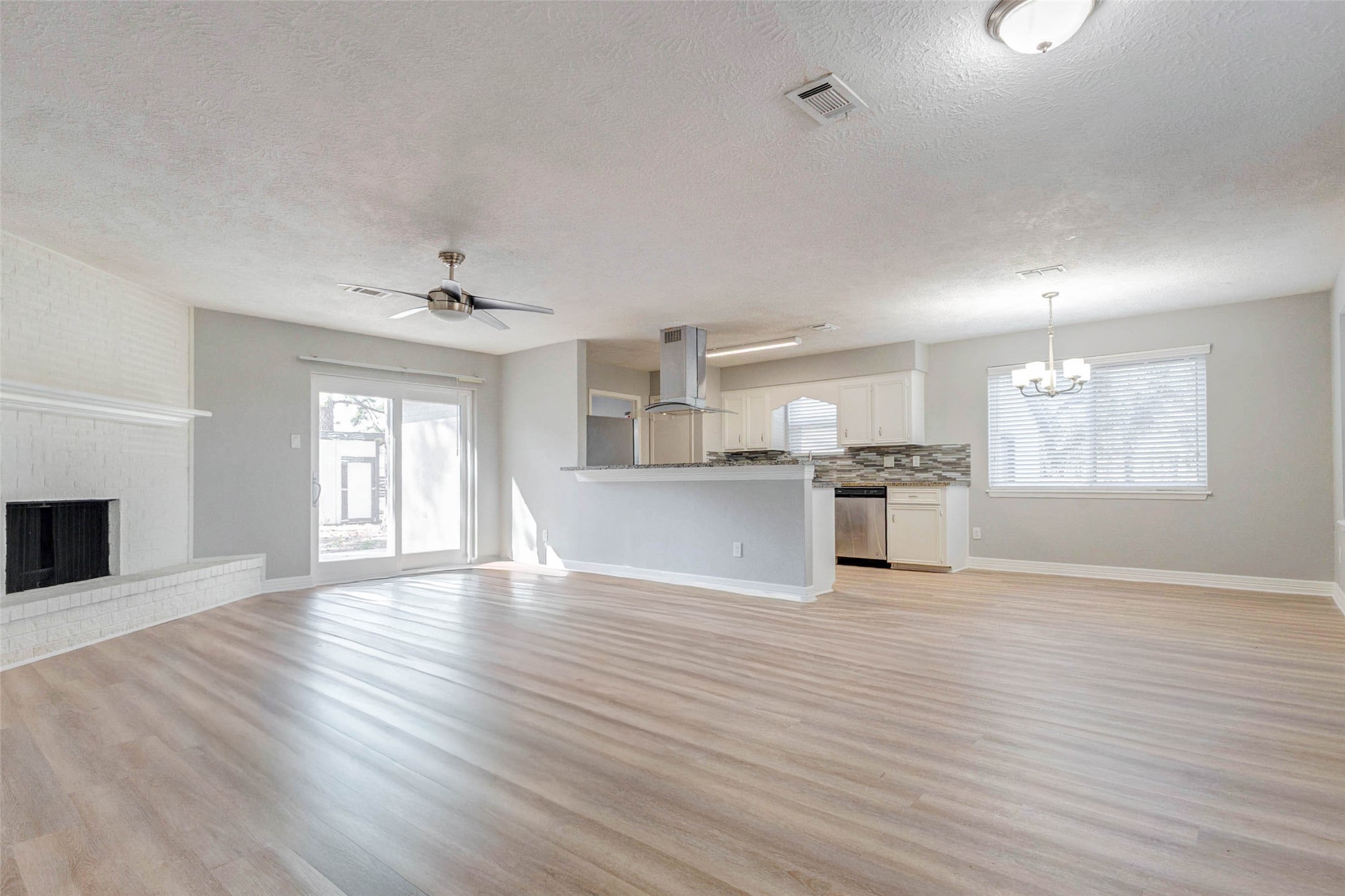 18526 Fenske Road Cypress, TX 77433 - Photo 7 of 32 Step inside to a light filled interior featuring luxury vinyl plank flooring, updated paint, and thoughtful improvements throughout.
