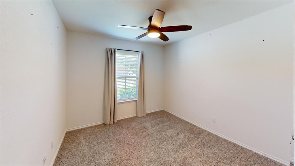 2210 Alamo Road Sherman, TX 75090 - Photo 8 of 17 Carpeted room featuring a ceiling fan with integrated lighting, a window with blinds, and neutral-toned walls