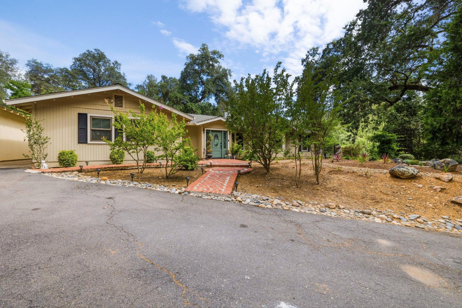 11460 Racetrack Road Sonora, CA 95370 - Photo 3 of 46 a view of a road with a house in the background