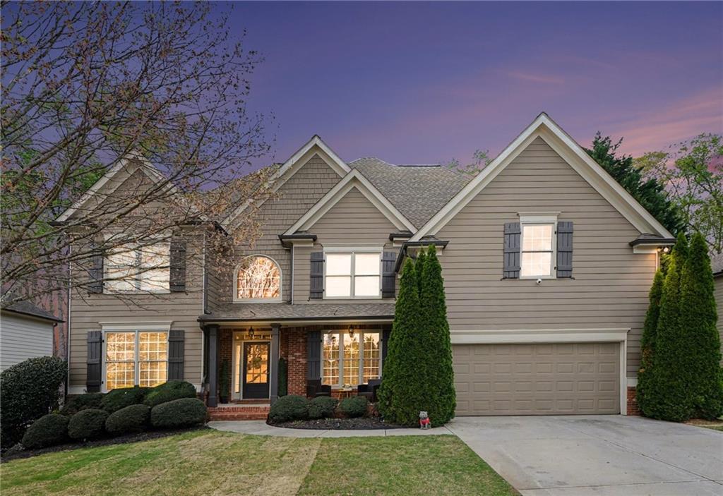 1958 Mapmaker Drive Northeast Dacula, GA 30019 - Photo 1 of 35 a front view of a house with a yard and garage