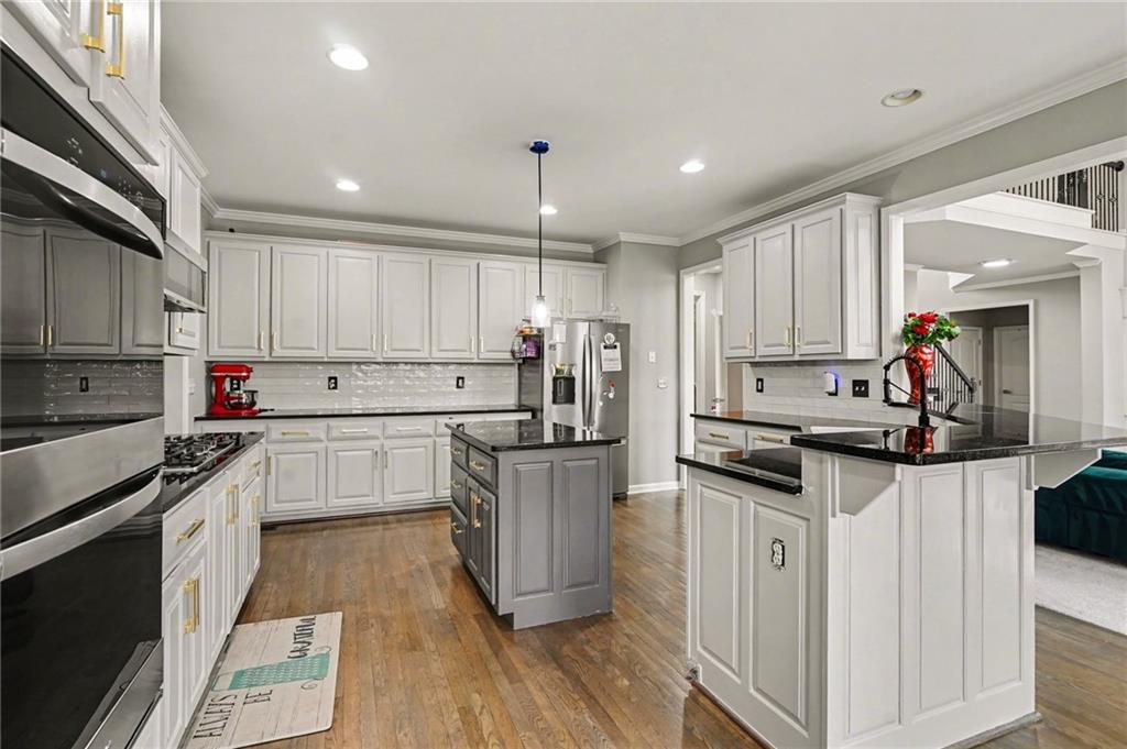 1958 Mapmaker Drive Northeast Dacula, GA 30019 - Photo 13 of 35 a kitchen with white cabinets sink and stainless steel appliances