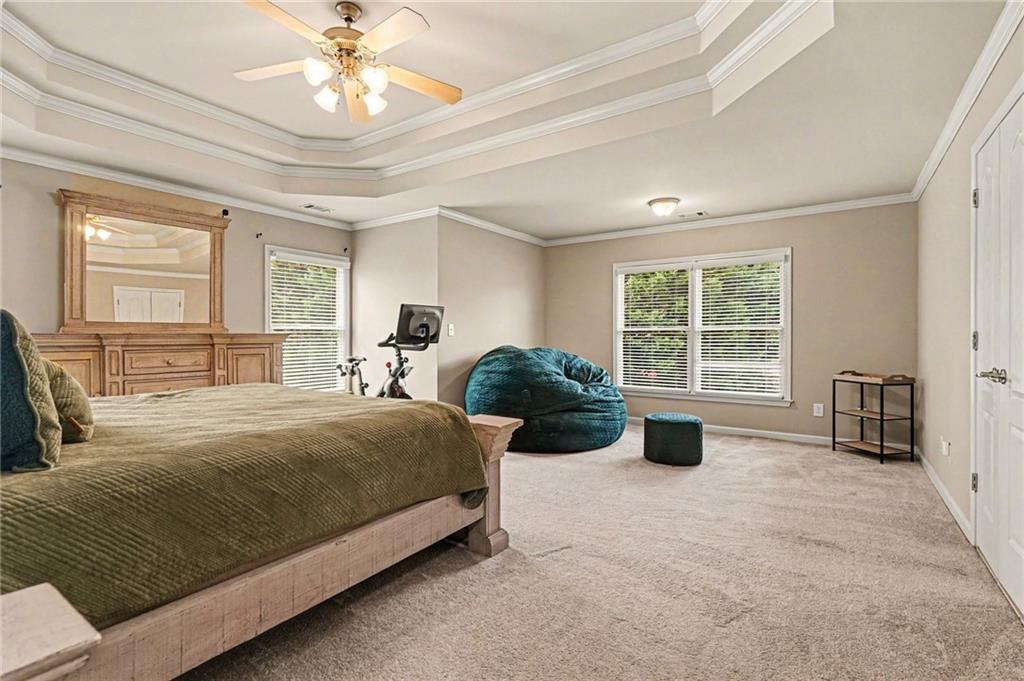 1958 Mapmaker Drive Northeast Dacula, GA 30019 - Photo 16 of 35 a spacious bedroom with a bed and a large window