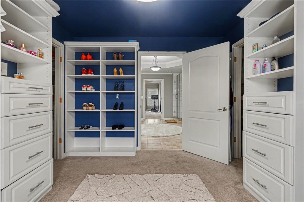 1958 Mapmaker Drive Northeast Dacula, GA 30019 - Photo 20 of 35 a view of walk in closet with clothes and shoes