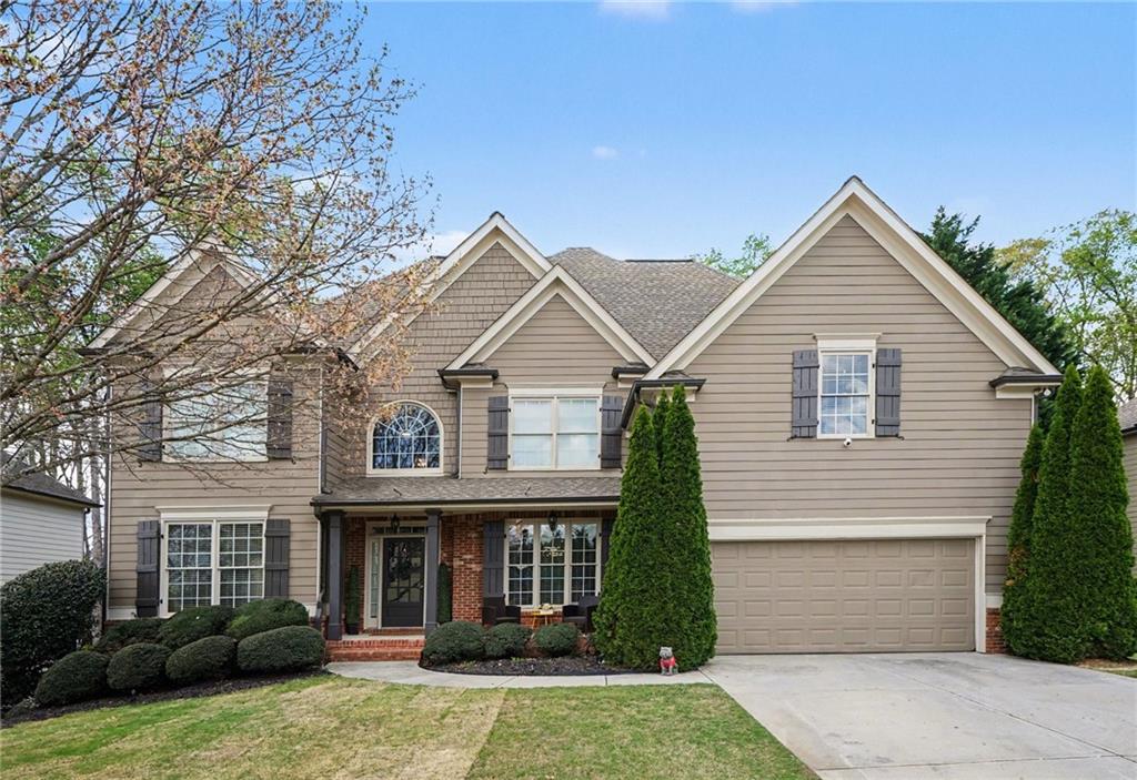 1958 Mapmaker Drive Northeast Dacula, GA 30019 - Photo 2 of 35 a view of a house with a yard and plants