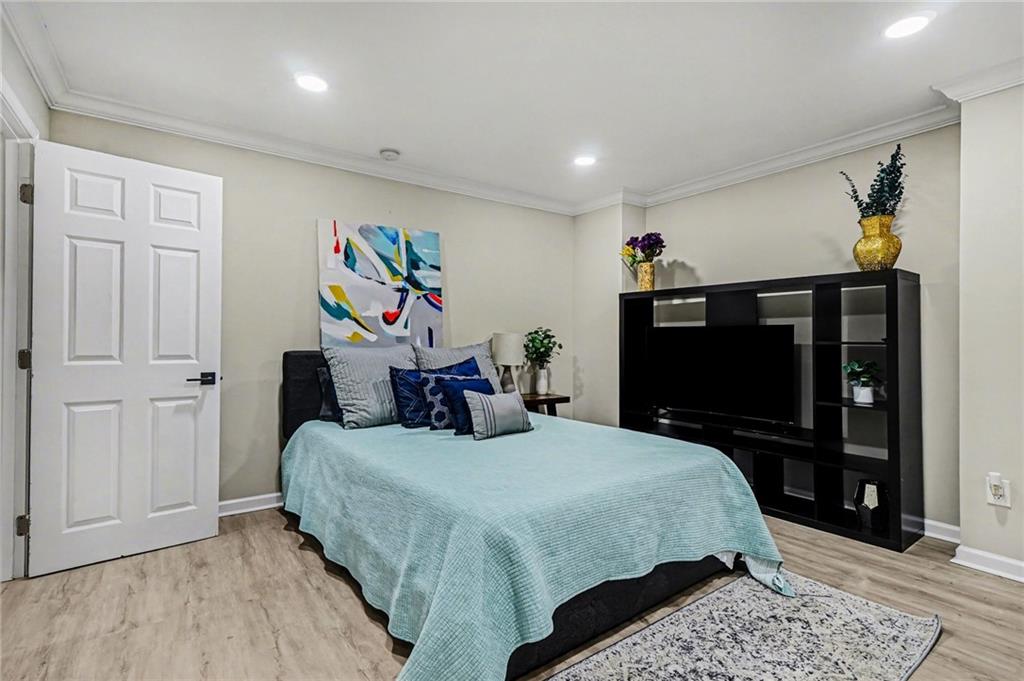 1958 Mapmaker Drive Northeast Dacula, GA 30019 - Photo 22 of 35 a bedroom with a bed and a flat screen tv