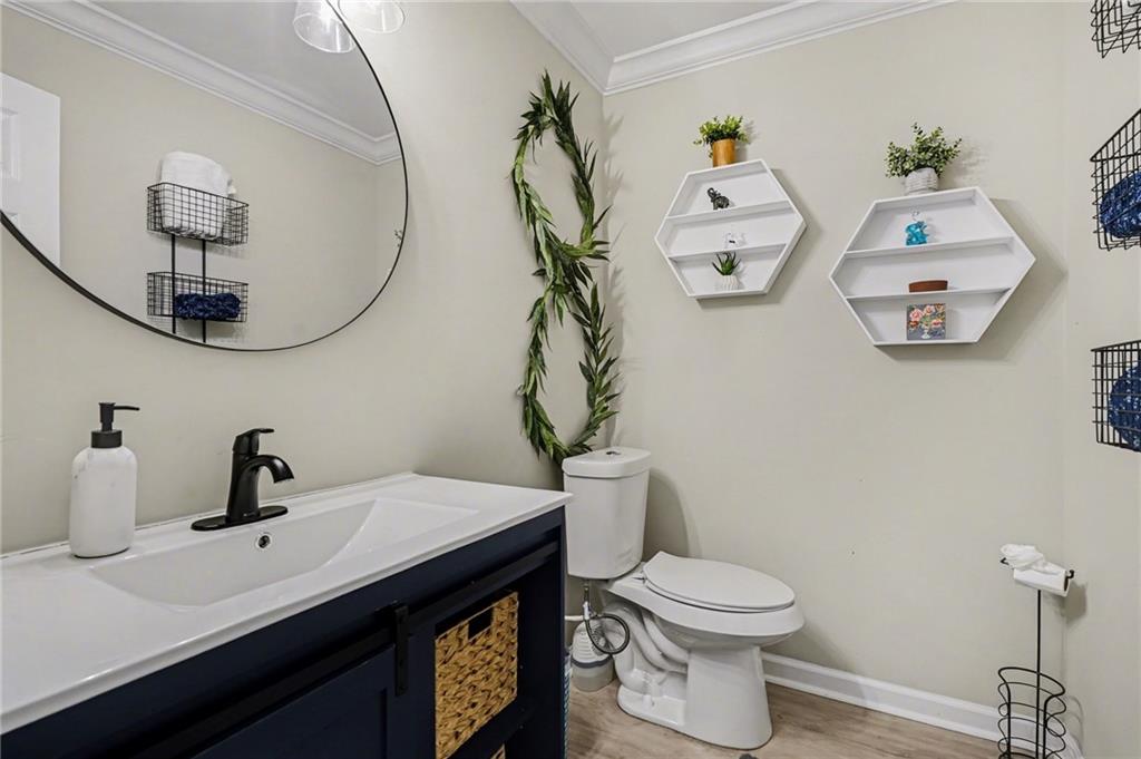 1958 Mapmaker Drive Northeast Dacula, GA 30019 - Photo 23 of 35 a bathroom with a sink a toilet and mirror