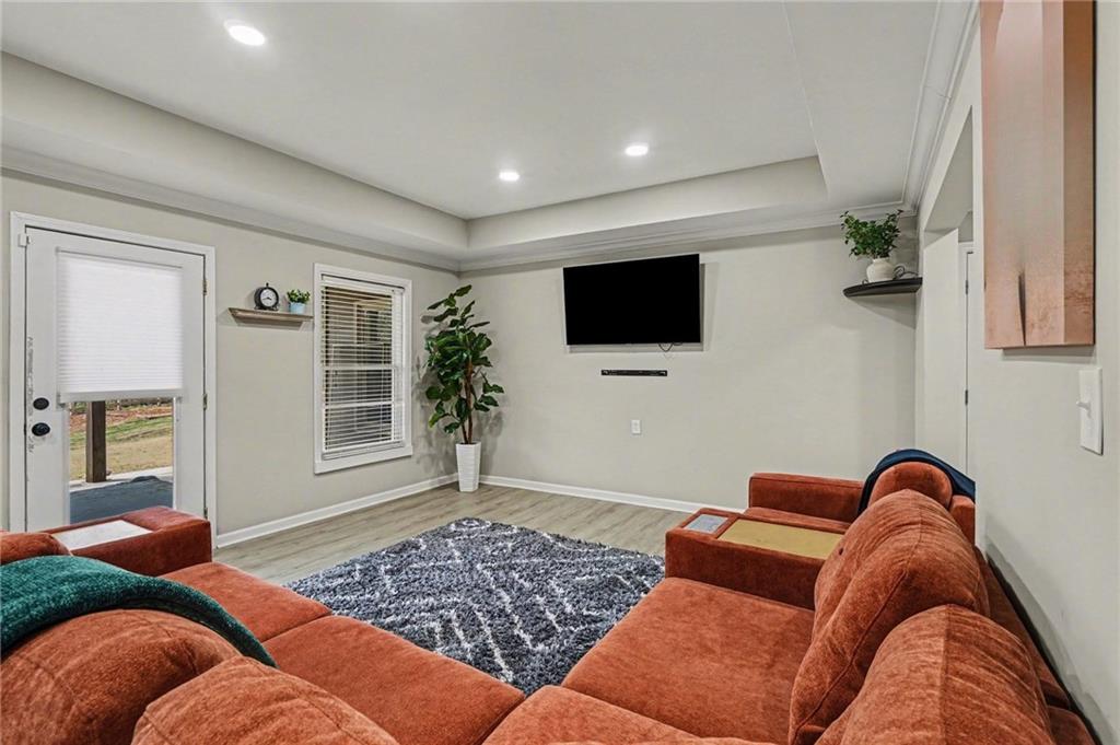 1958 Mapmaker Drive Northeast Dacula, GA 30019 - Photo 25 of 35 a living room with furniture and a flat screen tv