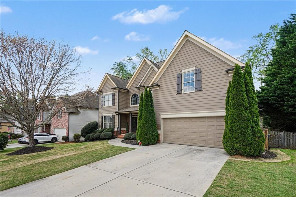 1958 Mapmaker Drive Northeast Dacula, GA 30019 - Photo 3 of 35 a view of a house with a yard and large tree