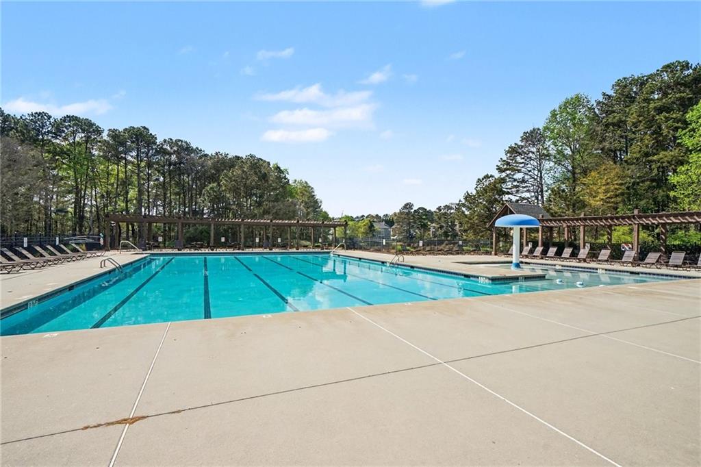 1958 Mapmaker Drive Northeast Dacula, GA 30019 - Photo 32 of 35 a view of a swimming pool with an outdoor space and seating area