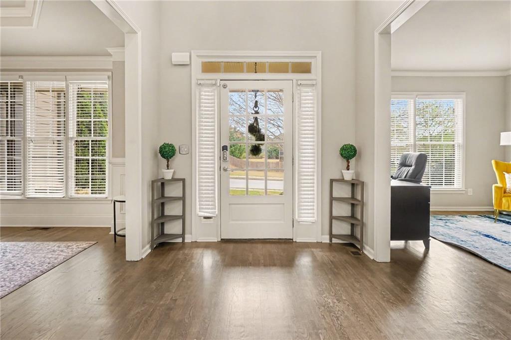 1958 Mapmaker Drive Northeast Dacula, GA 30019 - Photo 4 of 35 a view of a livingroom with wooden floor and windows