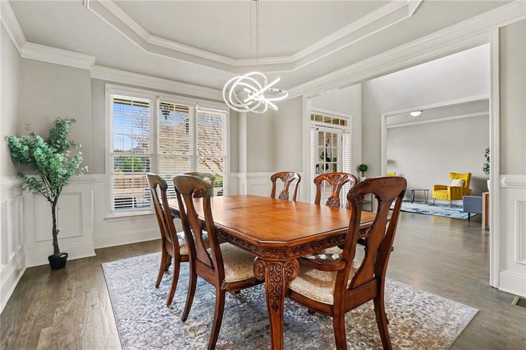 1958 Mapmaker Drive Northeast Dacula, GA 30019 - Photo 6 of 35 a view of a a dining room with furniture window and wooden floor