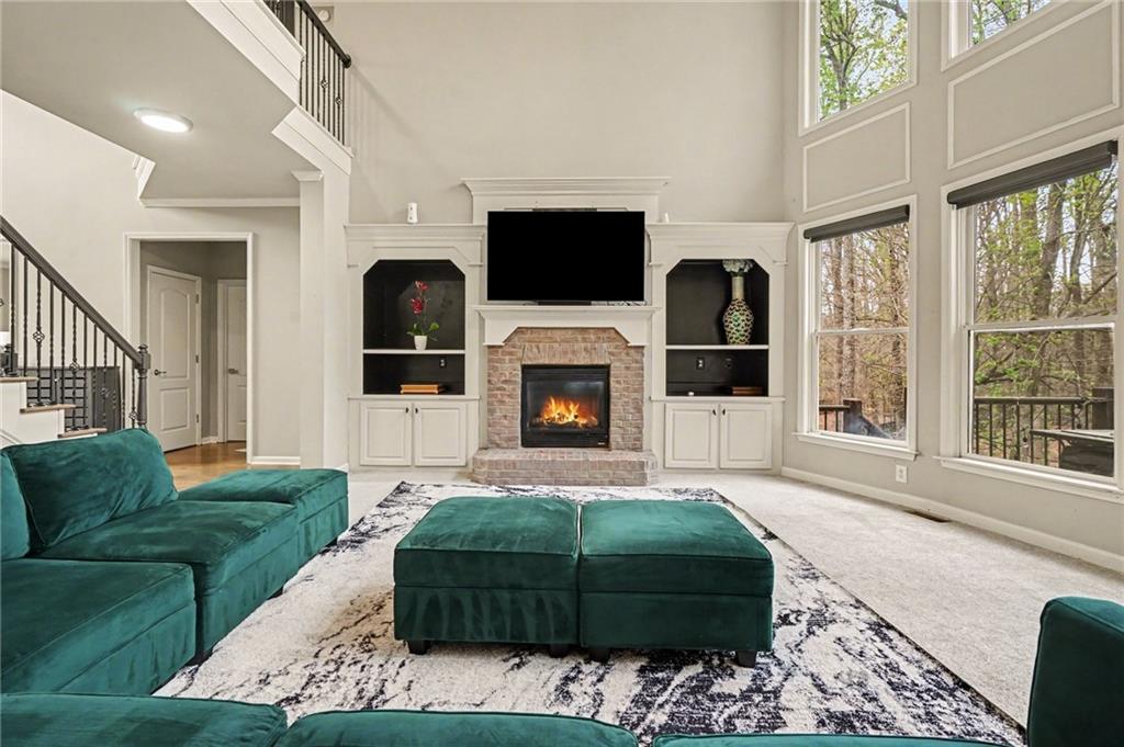 1958 Mapmaker Drive Northeast Dacula, GA 30019 - Photo 9 of 35 a living room with furniture flat screen tv and a fireplace