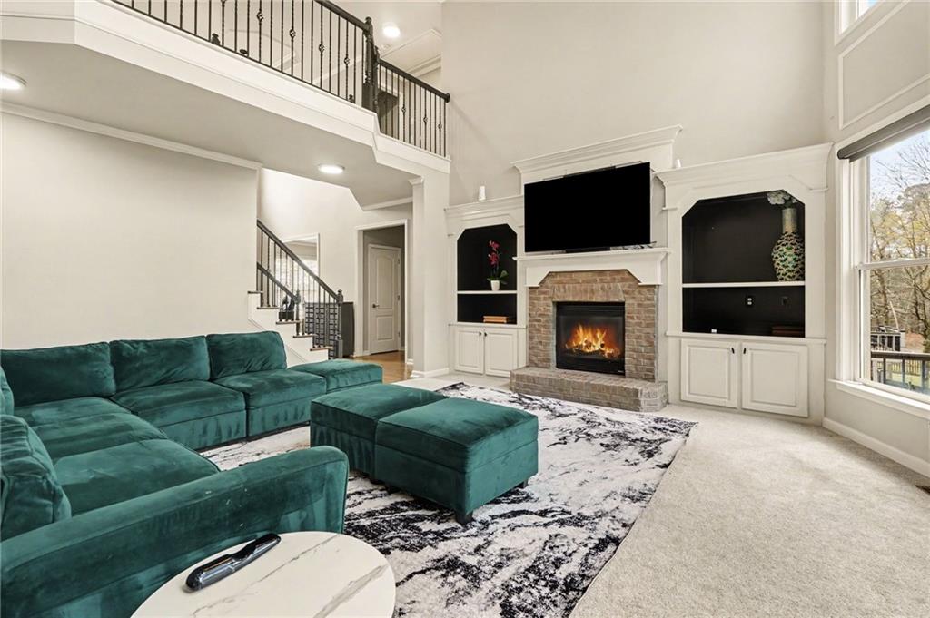 1958 Mapmaker Drive Northeast Dacula, GA 30019 - Photo 10 of 35 a living room with furniture a flat screen tv and a fireplace