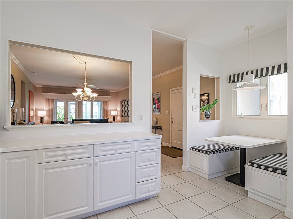 5035 Harmony Circle, Unit 101 Vero Beach, FL 32967 - Photo 12 of 36 a spacious bathroom with a double vanity sink and a mirror