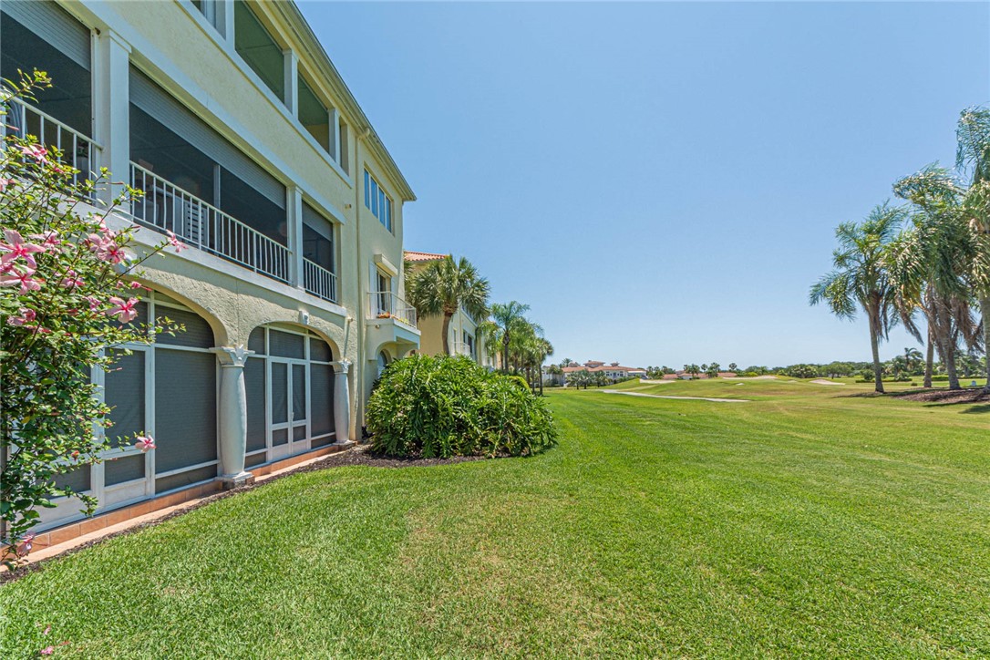 5035 Harmony Circle, Unit 101 Vero Beach, FL 32967 - Photo 2 of 36 a view of a house with a garden